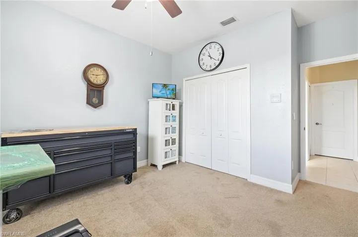 Bedroom with a closet, baseboards, carpet flooring, and visible vents