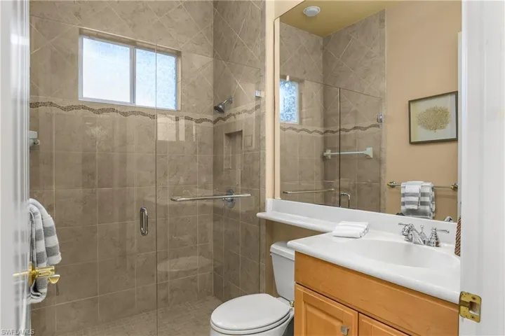 Bathroom featuring vanity and a shower stall