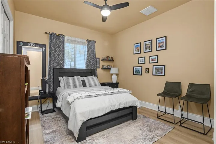 Bedroom with light wood finished floors and ceiling fan