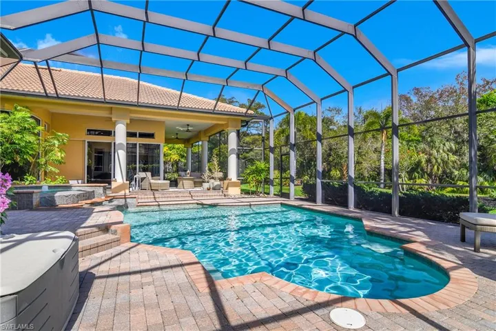 Relaxing pool / spa featuring a lanai, a patio, and a sunroom