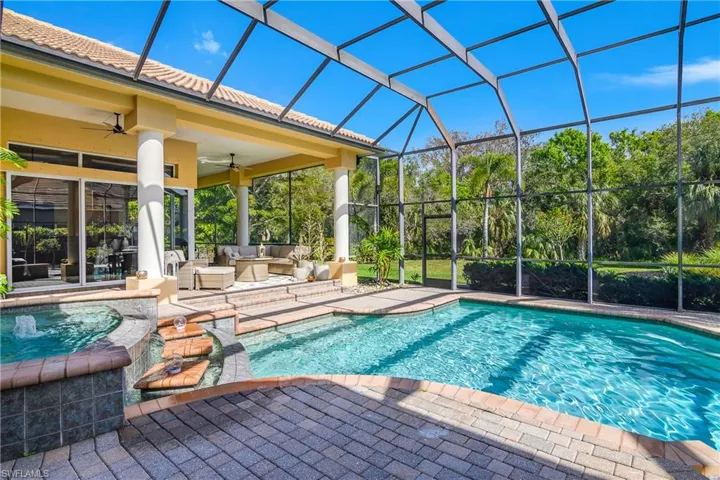 Swimming pool with an outdoor lounge area, a patio area, a lanai, and an outdoor hot tub