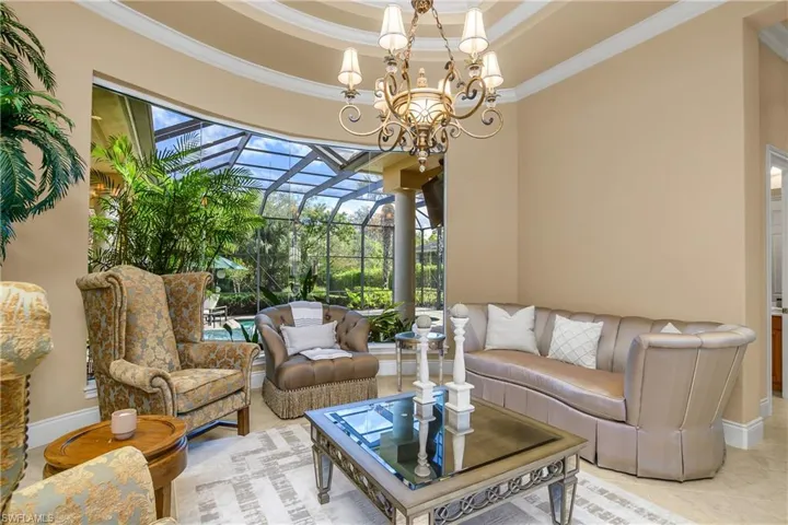 Sunroom featuring a patio, an outdoor hangout area, and hanging lights