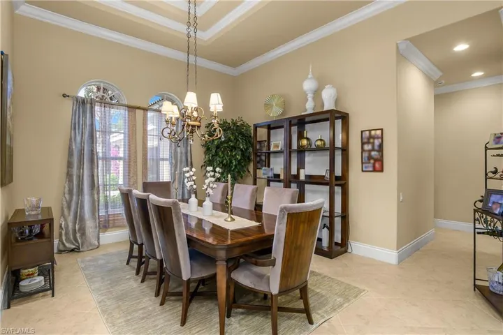 Dining space with crown molding and hanging lights