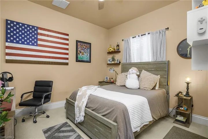 Bedroom featuring light carpet and ceiling fan