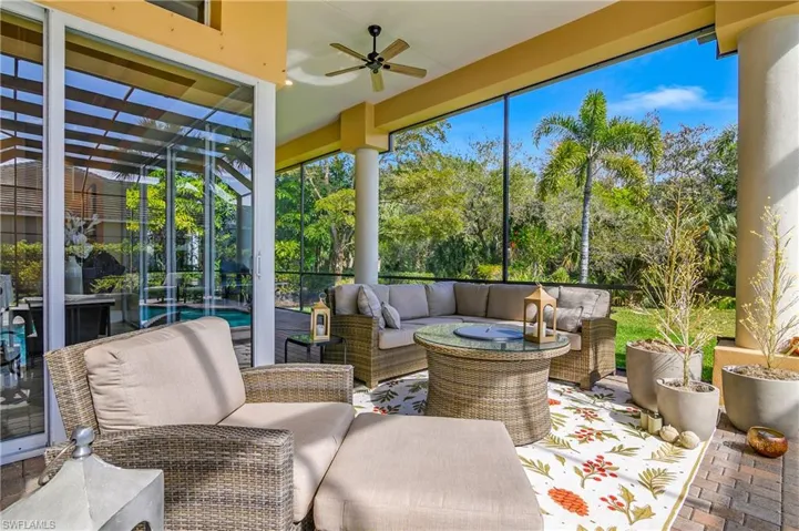 Sunroom featuring a ceiling fan, outdoor seating, and a patio