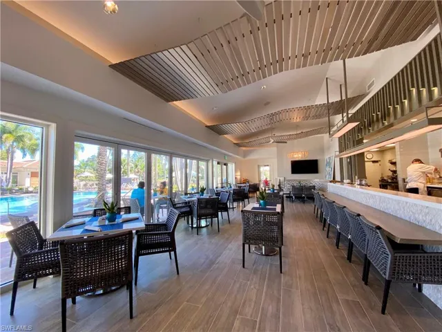 Dining space with wood finished floors and a high ceiling