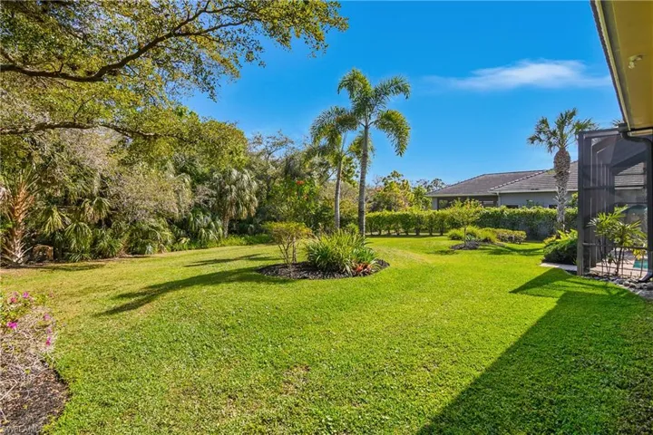 View of green lawn with a lanai