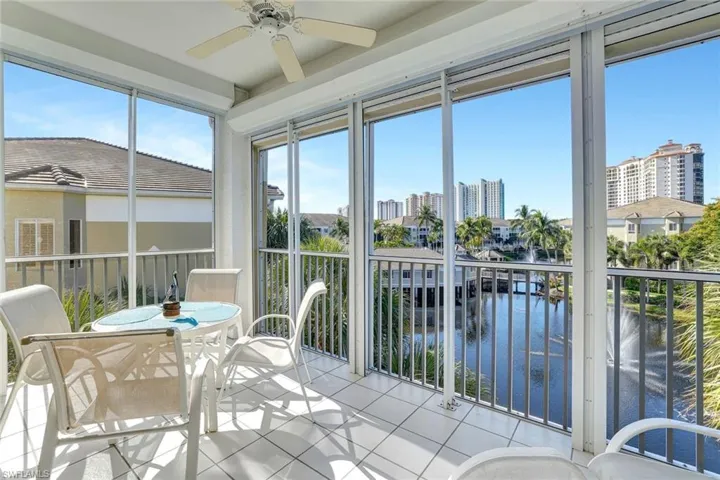 Sunroom with a water view and tile patterned floors