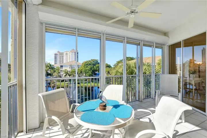 Sunroom featuring a water view and tile patterned flooring