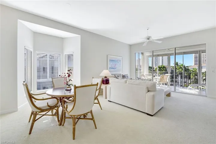 Carpeted dining area featuring baseboards and a ceiling fan