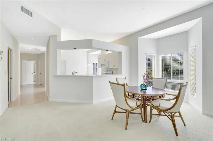 Dining area with light carpet