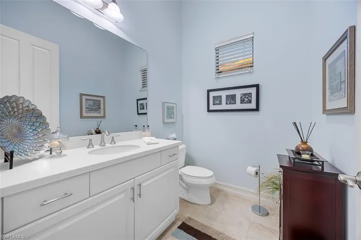 Bathroom featuring tile patterned flooring, vanity, and toilet