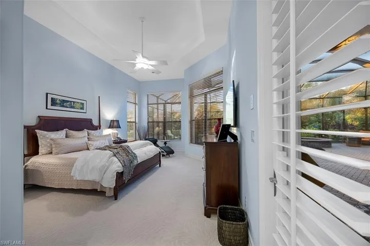 Bedroom featuring ceiling fan and light carpet