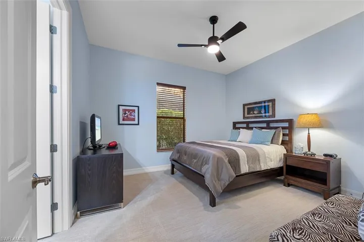 Bedroom with light carpet and ceiling fan