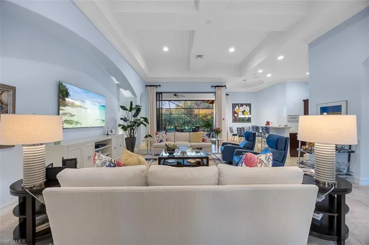 Living room featuring beam ceiling, ornamental molding, and coffered ceiling