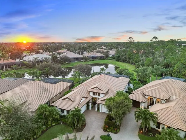 Aerial view at dusk featuring a water view