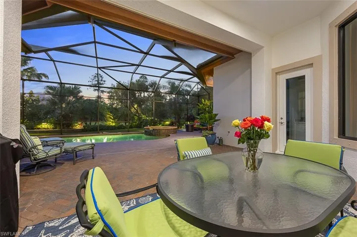 View of patio / terrace featuring a lanai