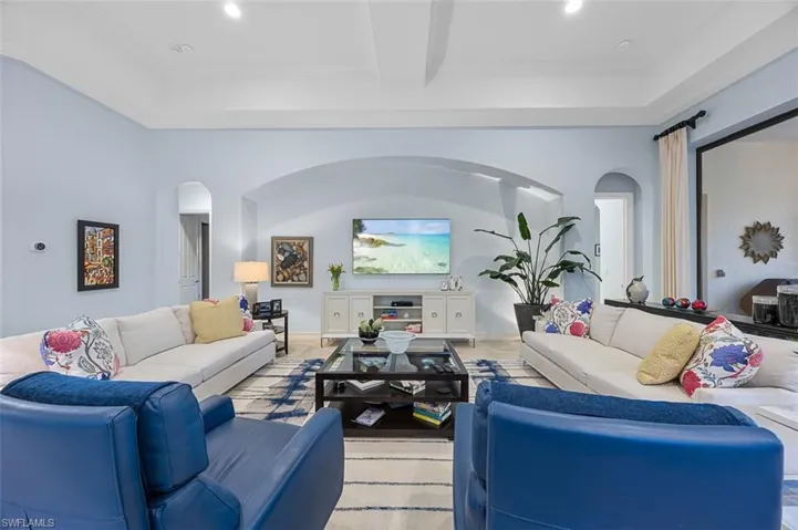 Living room with beam ceiling and crown molding