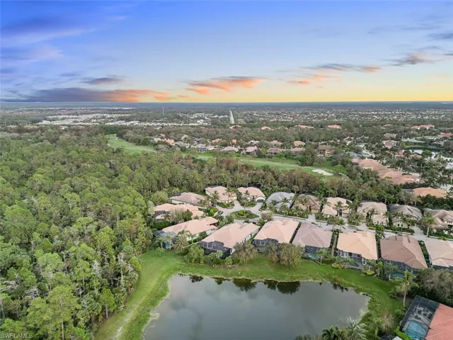 Aerial view at dusk featuring a water view