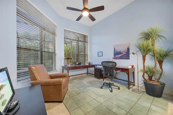 Office space with vaulted ceiling and ceiling fan