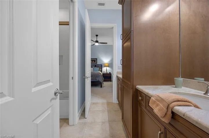 Bathroom with ceiling fan and tile patterned flooring