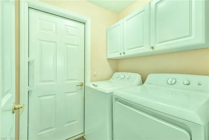 Laundry area with washer and clothes dryer and cabinet space