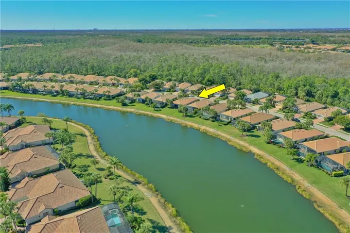 Aerial view of property's location with nearby suburban area and a nearby body of water
