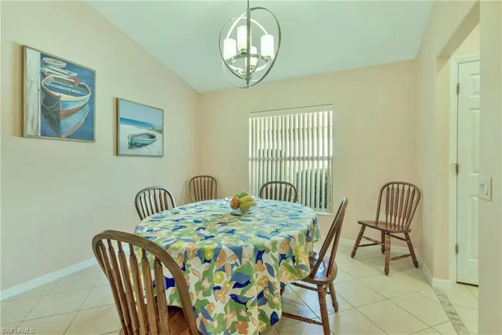 Dining room featuring light tile patterned flooring and suspended lighting