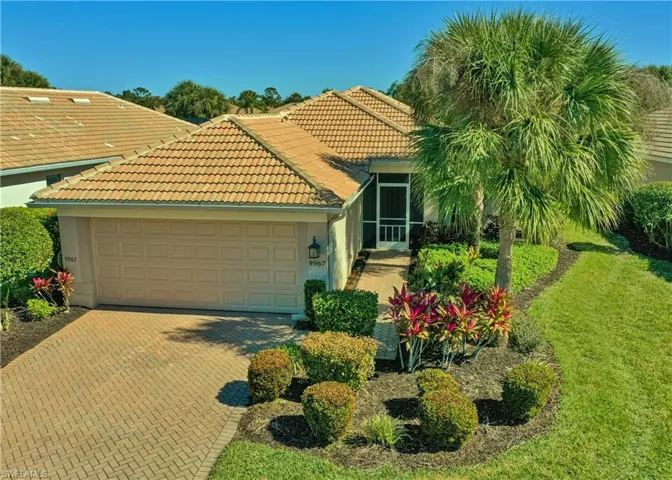 View of front of property with stucco siding, decorative driveway, a garage, a tile roof, and a front yard