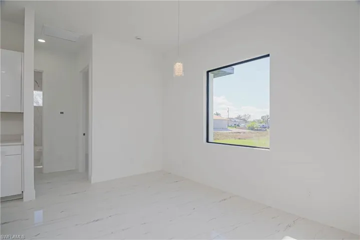 Spare room featuring marble finish floor and recessed lighting
