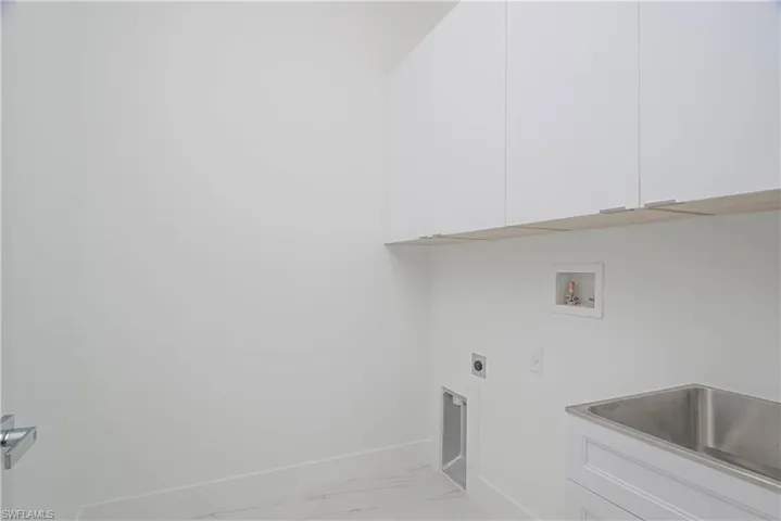 Laundry area with washer hookup, a sink, marble finish floor, cabinet space, and electric dryer hookup