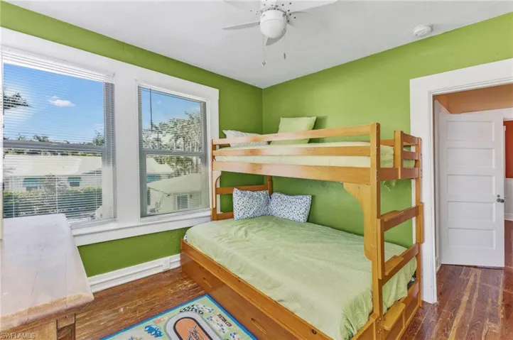 Bedroom with wood-type flooring and a ceiling fan