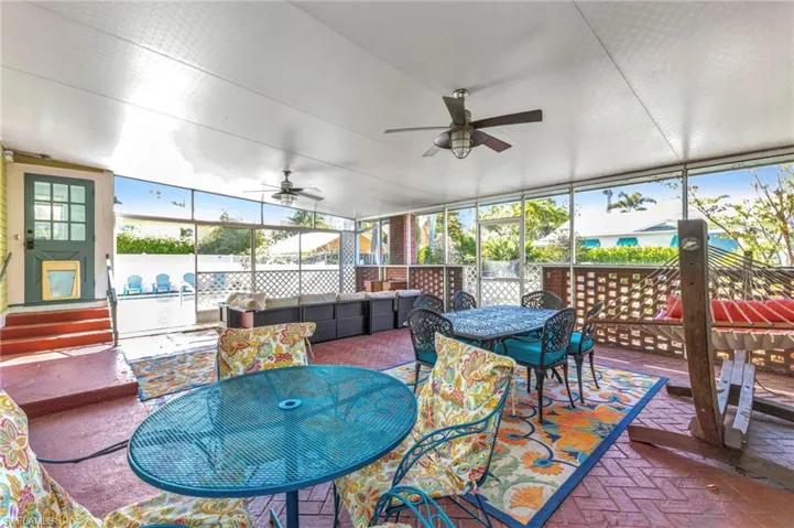 Sunroom / solarium with outdoor dining area, plenty of natural light, and ceiling fan