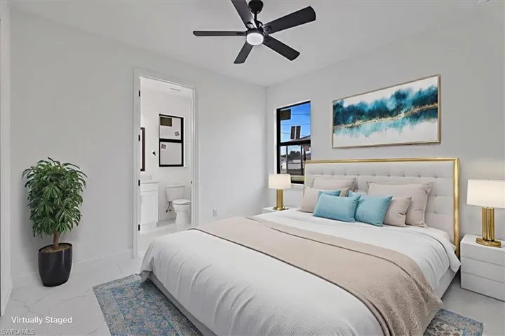 Bedroom with a ceiling fan and ensuite bath