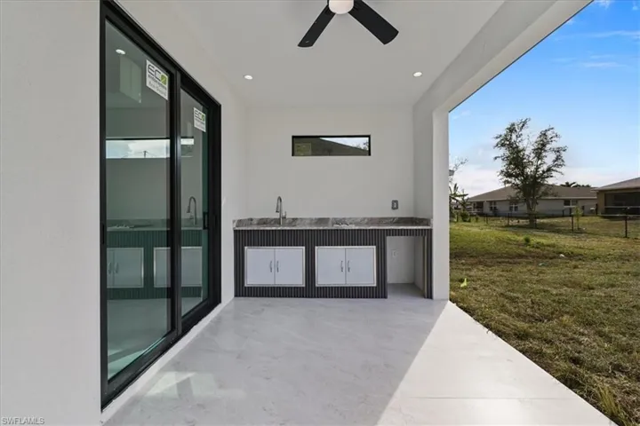 View of patio / terrace with ceiling fan and an outdoor kitchen