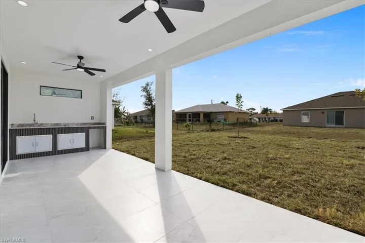 View of patio / terrace with ceiling fan and an outdoor kitchen