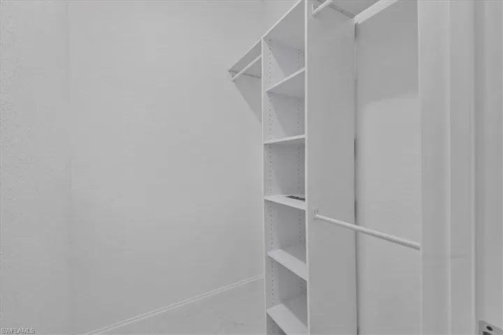 Spacious closet with light marble finish flooring