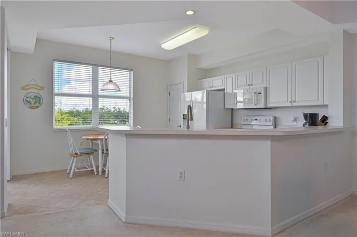 The freshly painted walls accentuates the great amount of light pouring into the kitchen.
