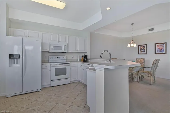 The kitchen is prepared for the new owner; glassware, dishware, cutlery, pots, and pans, and other items remain in place.