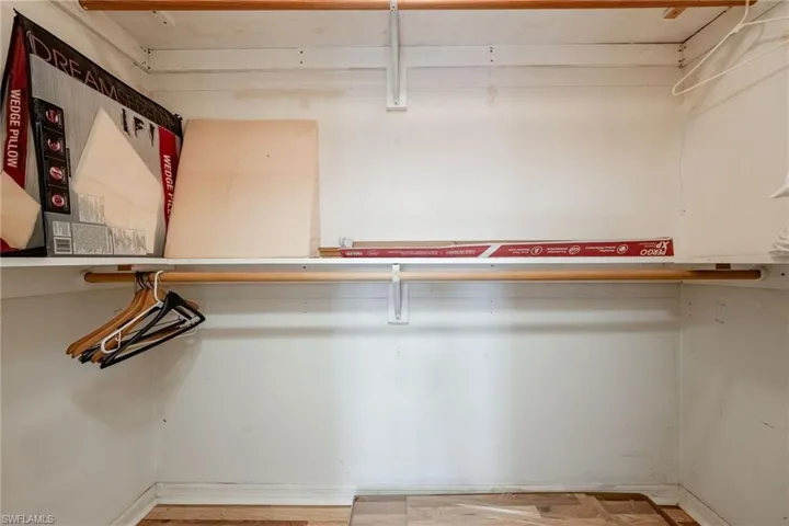 Walk in closet with wood finished floors