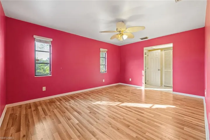 Empty room with a ceiling fan and wood finished floors