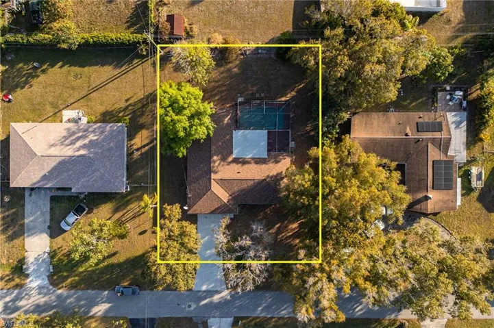 Aerial view of property and surrounding area featuring property boundaries highlighted
