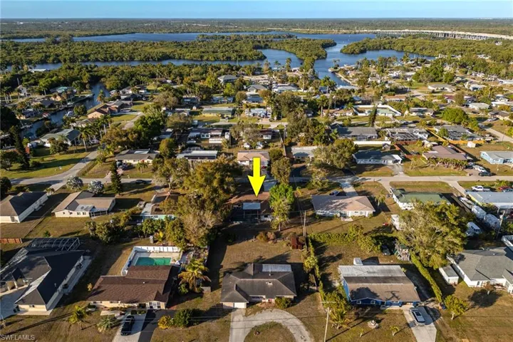 Aerial view of property's location with nearby suburban area and a large body of water