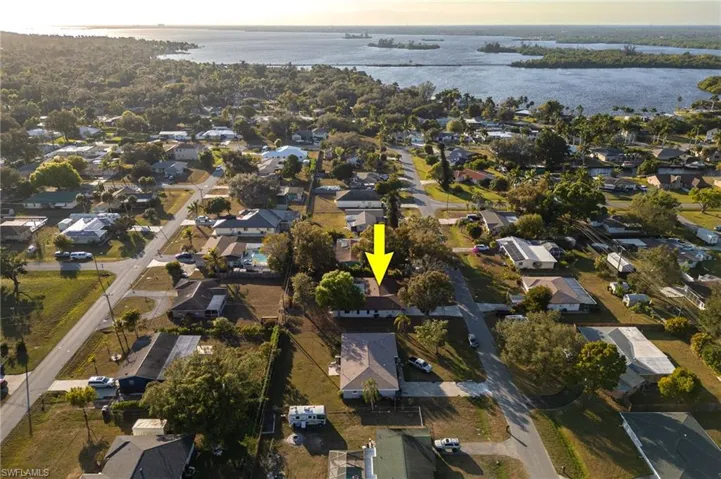 Aerial view of property's location with nearby suburban area and a large body of water