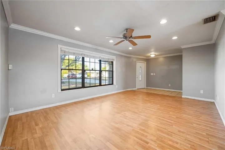 Unfurnished room with a ceiling fan, light wood finished floors, recessed lighting, and crown molding
