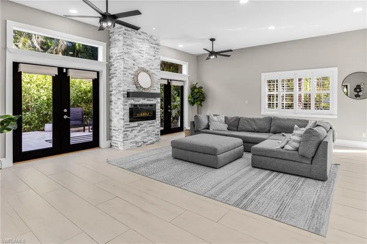 Kitchen featuring beverage cooler, dishwasher, recessed lighting, white cabinets, and light stone counters