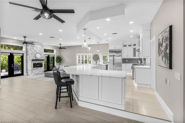 Dining area with recessed lighting, light wood-style flooring, french doors, a chandelier, and ceiling fan