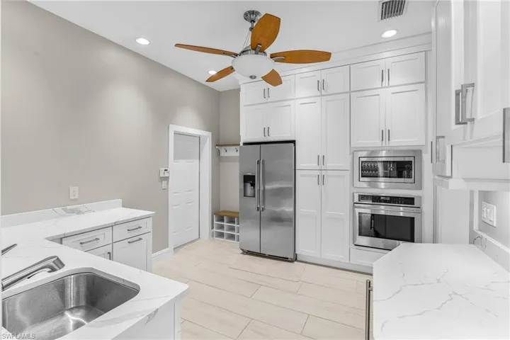 Living area with light wood finished floors, recessed lighting, and ceiling fan