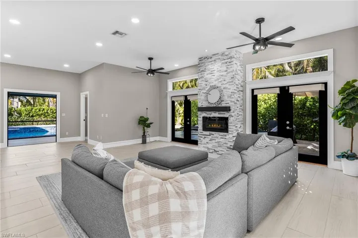 Kitchen featuring stainless steel appliances, light countertops, ceiling fan, recessed lighting, and white cabinetry