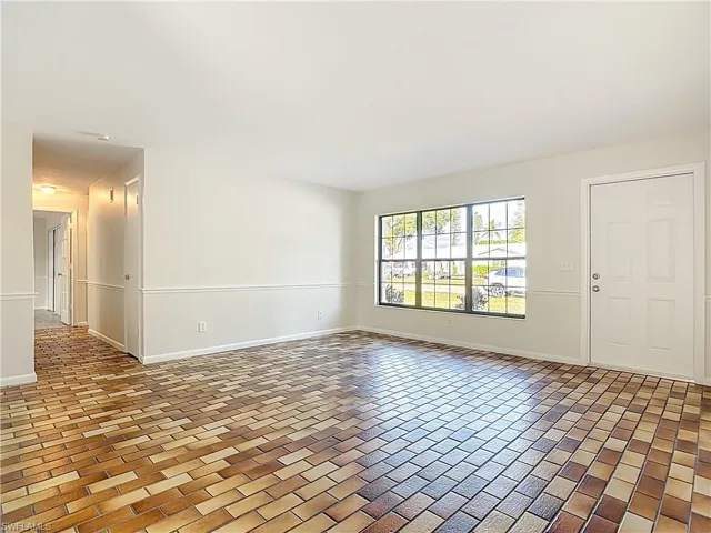 Empty room featuring baseboards